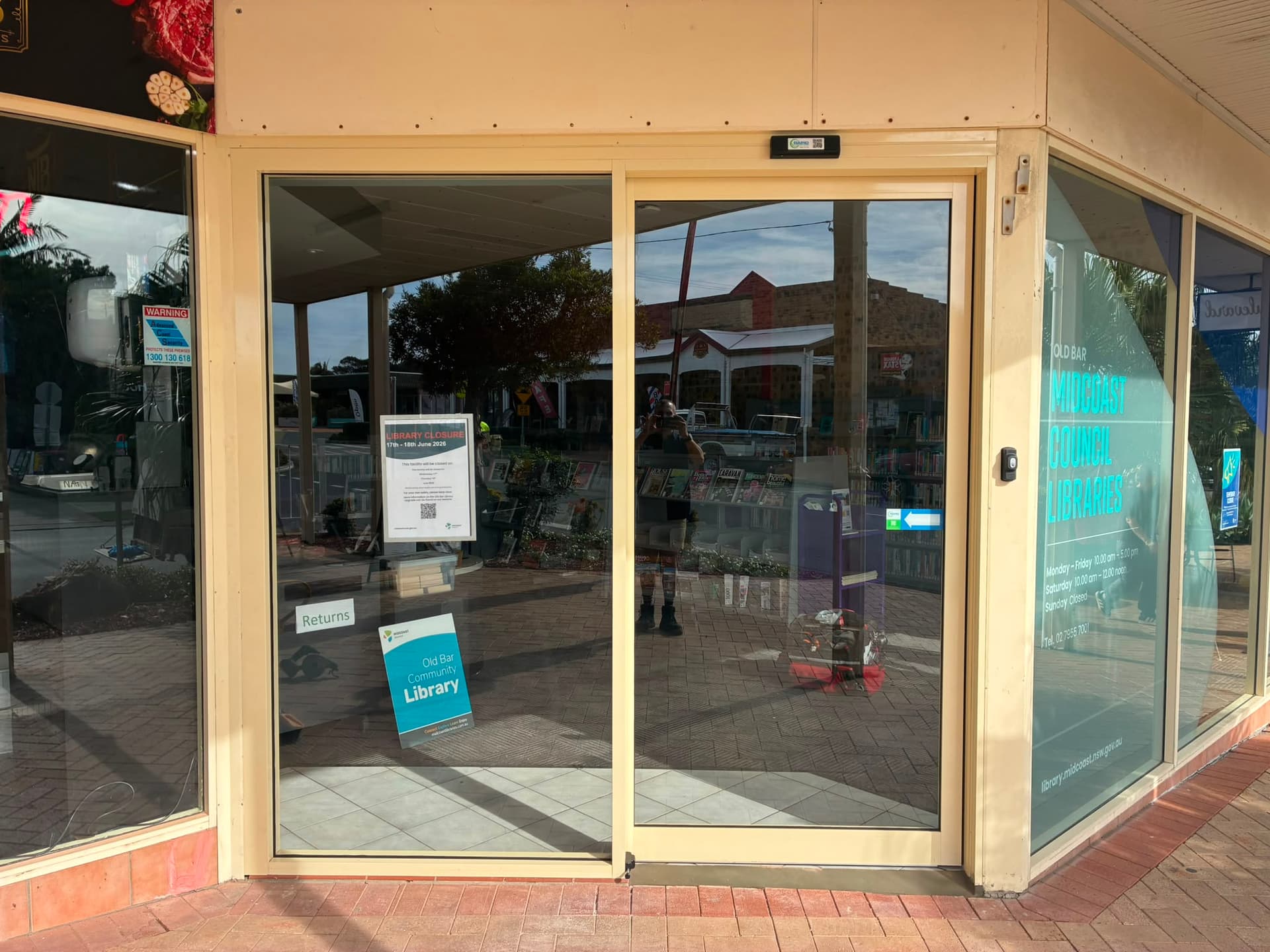 Automatic sliding glass entrance at MidCoast Council Library.