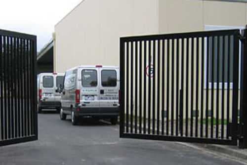 A double swing gate with a keypad entry system.